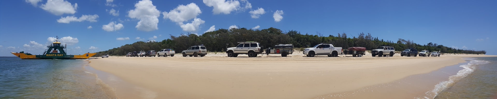 Fraser Island Cleanup, four wheel drives lined up on the beach to board the barge